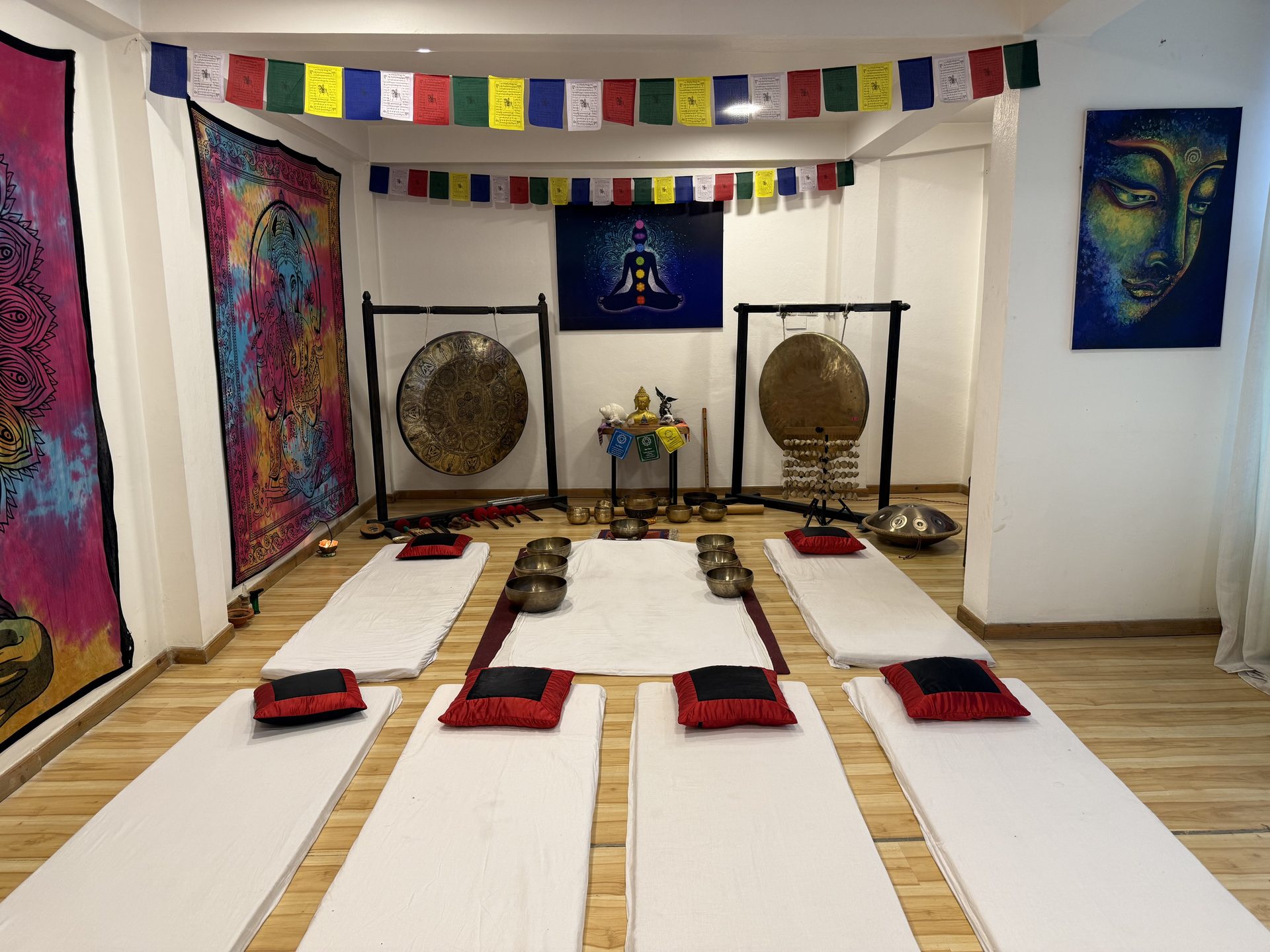 Vedic Healing sound-therapy room in Kathmandu with gongs, singing bowls, meditation mats and Tibetan prayer flags